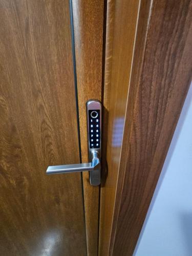 a door handle with a remote control on a wooden door at STUDIO 7 in Veliko Tŭrnovo