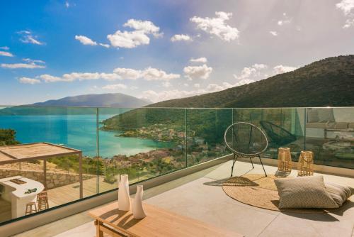 a balcony with a view of the water and mountains at Kefalonia Grande Horizon in Ayia Evfimia