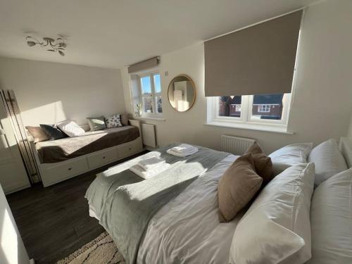 a bedroom with a bed and a couch in it at Entire cosy home in Liverpool Marina in Liverpool