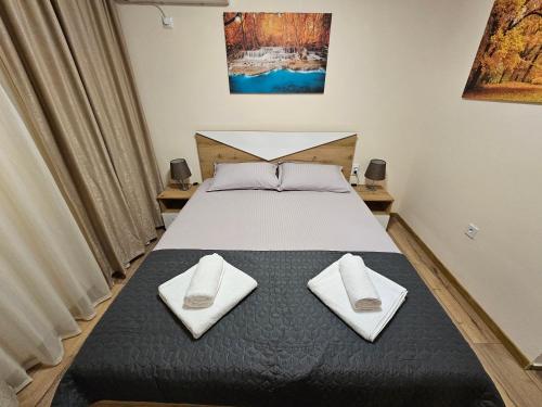 a bedroom with a bed with white towels on it at STUDIO 7 in Veliko Tŭrnovo