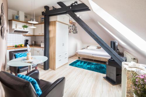 a room with a bed and a table and chairs at Seepferdchen in der Villa Medici in Norderney