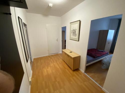 um quarto branco com uma cama e piso em madeira em Monteur und Ferienwohnung in Magdeburg BTR em Magdeburg