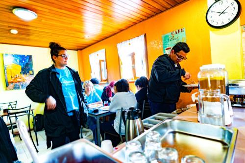 a group of people standing in a restaurant kitchen at La Casa del Molino Blanco B&B in Baños