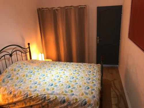 - une chambre avec un lit et une porte avec un rideau dans l'établissement Joli appartement calme à Binic dans rue piétonne, à Binic