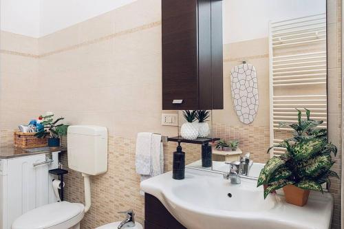 a bathroom with a white sink and a toilet at Loft - Comfort Studio - [10m Piazza Maggiore] in Bologna