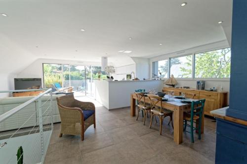 a kitchen and dining room with a table and chairs at La terrasse du Porjou classée 3 étoiles in Ploubazlanec