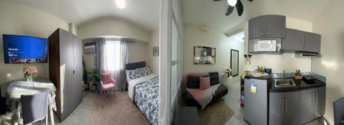 a small room with a kitchen and a living room at Staycation @ AMAIA SJDM Bulacan in Tunkong Manga