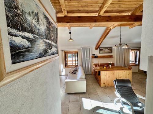 a living room with a couch and a table at Chalet Paradisi in Castello Tesino