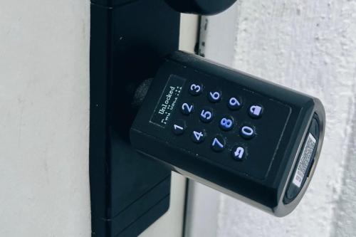 a black remote control attached to a wall at SpaceOne Vienna A2 - Shared Apartment in Vienna