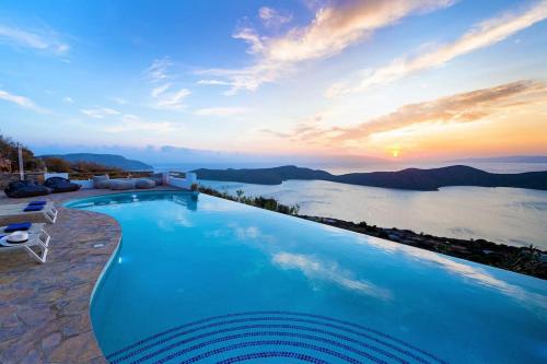 a large swimming pool with a view of the water at Luxury Villa Orea, Elounda (owner's listing) in Epáno Eloúnda