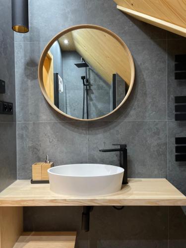 a bathroom with a white sink and a mirror at Apartament 920m n.p.m. in Zakopane
