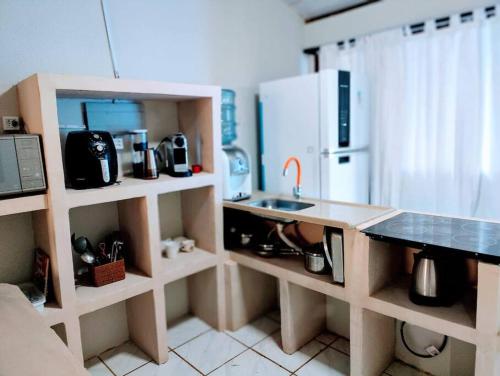 a small kitchen with a counter and a sink at Casa Beco do Céu in Fernando de Noronha