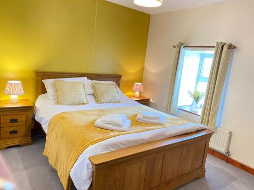 a bedroom with a bed with two towels on it at Captivating 5-Bed House with hottub near to Brecon in Brecon