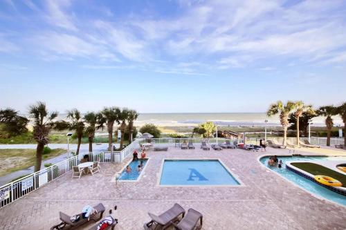 a resort with a pool and the beach at Amazing Atlantica Condo 1st Floor in Myrtle Beach