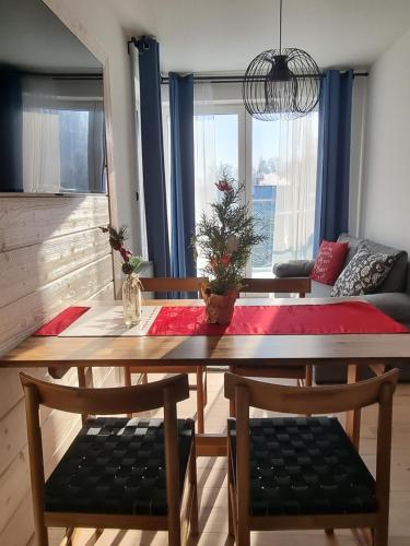 a dining room table with a christmas tree on it at Villa Olimpijska 2 - Centrum in Wisła