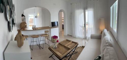 a living room with a couch and a table at apartamento nº 7 cala pregonda in Cala Blanca