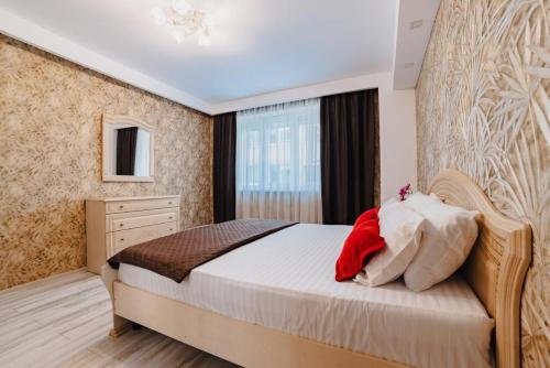 a bedroom with a large bed and a window at Luxury Apartment Oasis in Timisul de Jos