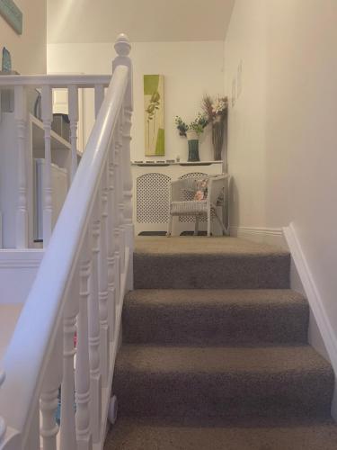 a stairway with a white railing and a stair case at Valentia Skellig Rooms - 7 km away from Portmagee in Valentia Island