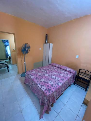 um quarto com uma cama e uma ventoinha em Casa para 4 personas, DOS HABITACIONES, excelente ubicación a 30 metros del casino, y a 50 metros de la parte principal de costanera , equipada entera, wifi em Gualeguaychú