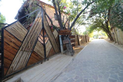 a wooden fence with a planter on the side of a street at Casa AVA in Mazunte