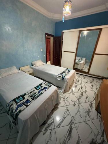 En eller flere senge i et værelse på Villa spacieuse 200 m à la plage