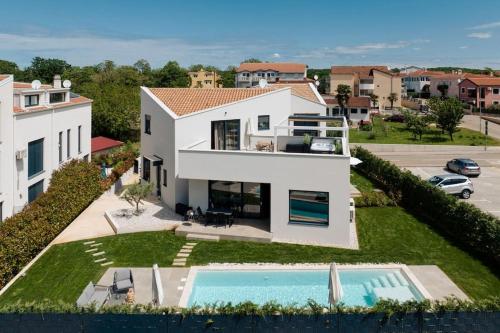 an aerial view of a house with a swimming pool at Villa Costa by Briskva in Funtana