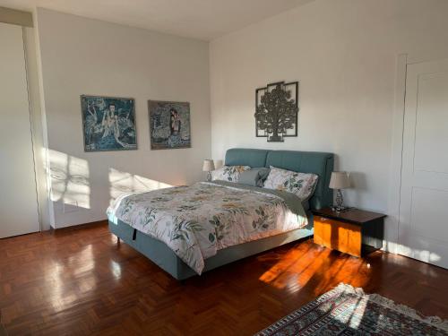 a bedroom with a bed and a wooden floor at VILLA TARA in Quercianella