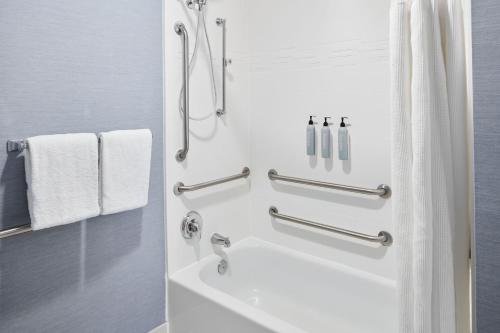 a bathroom with a tub and a shower with towels at Residence Inn By Marriott Charleston Mt. Pleasant in Charleston