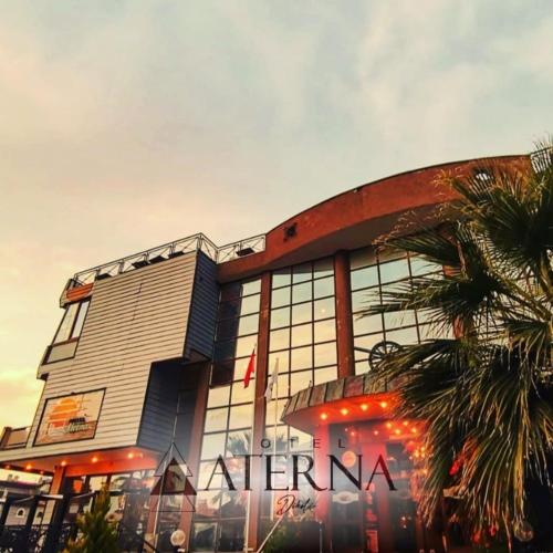 a building with a sign in front of it at ATERNA HOTEL in Dikili