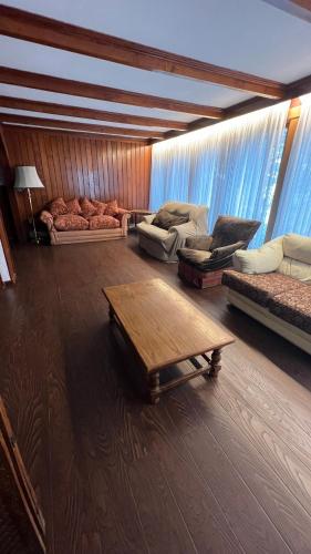 a living room with couches and a coffee table at Anoka House in Punta Arenas