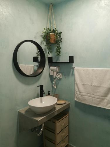 a bathroom with a sink and a mirror at Boho Sisi Resort - Poolside Oasis & Garden Vibes in Agios Nikolaos