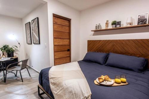 a bedroom with a bed with a tray of food on it at La Fábrica #2 La Constancia in Valle de Bravo