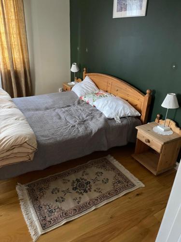 a bedroom with a bed and a table with a rug at Vacker villa i Fröseke in Fröseke