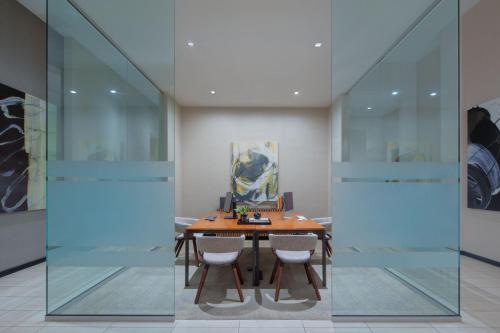 a table in a room with glass walls at AC Hotel by Marriott Fort Lauderdale Airport in Dania Beach
