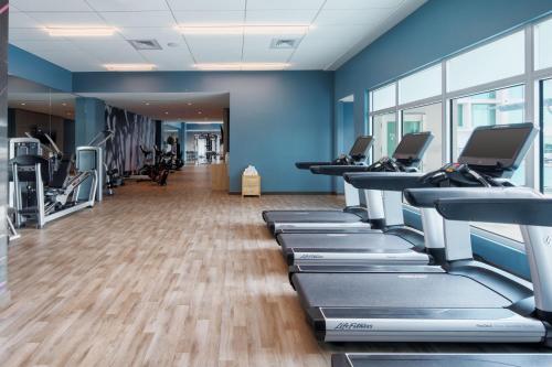 a gym with rows of treadmills and machines at AC Hotel by Marriott Fort Lauderdale Airport in Dania Beach