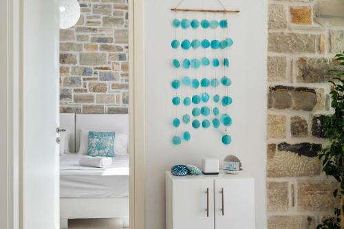 a room with a door with a wall with turquoise decorations at Aphrodite's Luxury Pearls 2 in Pitsidia