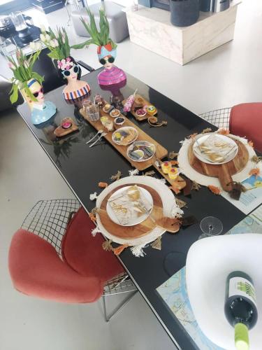a table with plates of food on top of it at Paradise Amsterdam bungalow of 80 m2 with private pool - inclusive, breakfast, parking, use of bikes, tourist tax and much more in Zandvoort