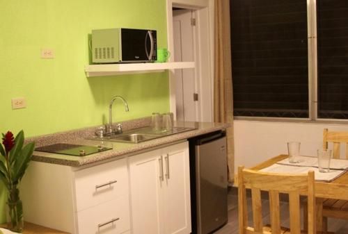a kitchen with a sink and a microwave at Super Precio in Guatemala