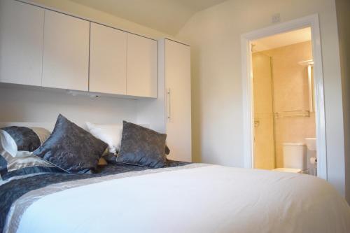 a bedroom with a large white bed with two pillows at Harbour Penthouse Whitby in Whitby