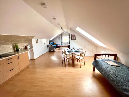 a kitchen and a living room with a table and chairs at WiLLA APART in Władysławowo