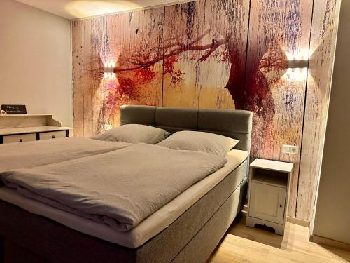 a bedroom with a bed with a wooden wall at DIE FeWo Bleicherode zwischen Harz und Kyffhäuser in Wipperdorf