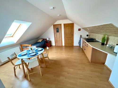 a kitchen and living room with a table and chairs at WiLLA APART in Władysławowo