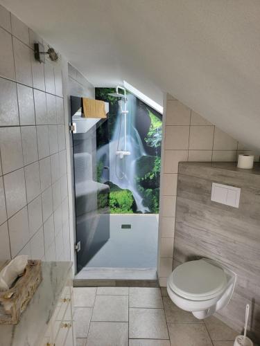a bathroom with a shower and a toilet in it at Falkenstein-Hütten in Bad Schandau