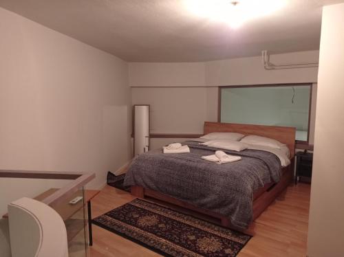 a bedroom with a bed with two towels on it at Ioa Loft in Ioannina