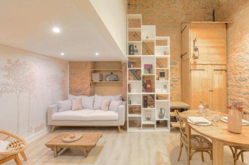 een woonkamer met een witte bank en een tafel bij Duplex de caractère en hypercentre in Lyon