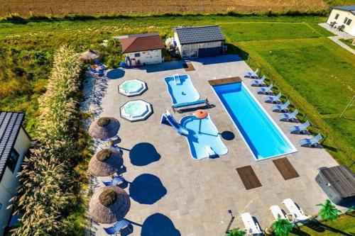an aerial view of a swimming pool with lounge chairs at Holiday resort with Pool Whirlpool Sauna Ustronie Morskie in Ustronie Morskie