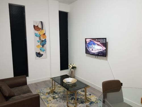 a living room with a couch and a table at Kingdom apartments in Wolverhampton