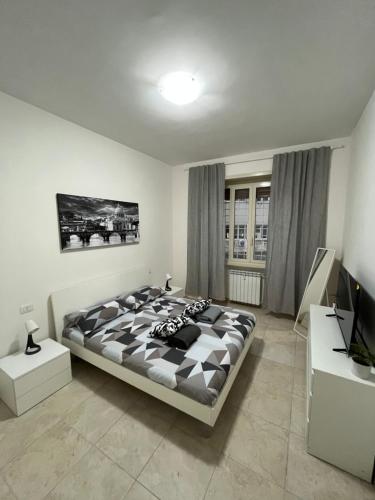 a bedroom with a large bed and a television at Monti Exclusive Apartment in Rome