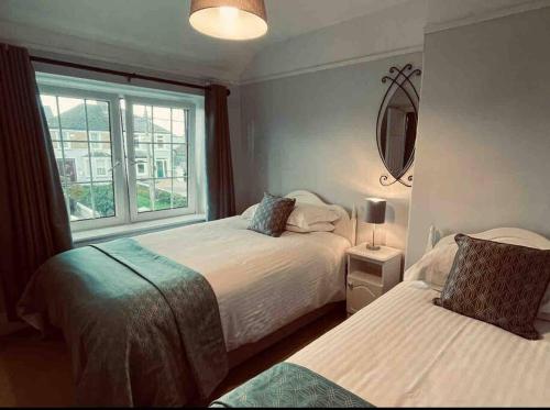 a bedroom with two beds and a window at Beautiful House In Town in Killarney
