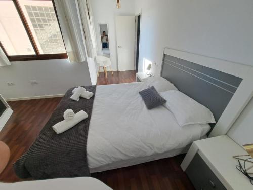 a bedroom with a large bed with towels on it at Atico TERRAZA DEL CARMEN in Salobreña